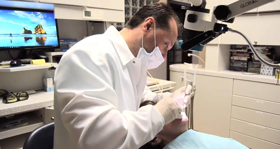 Berwyn, PA, restorative and cosmetic dentist Dr. Arhiri with patient